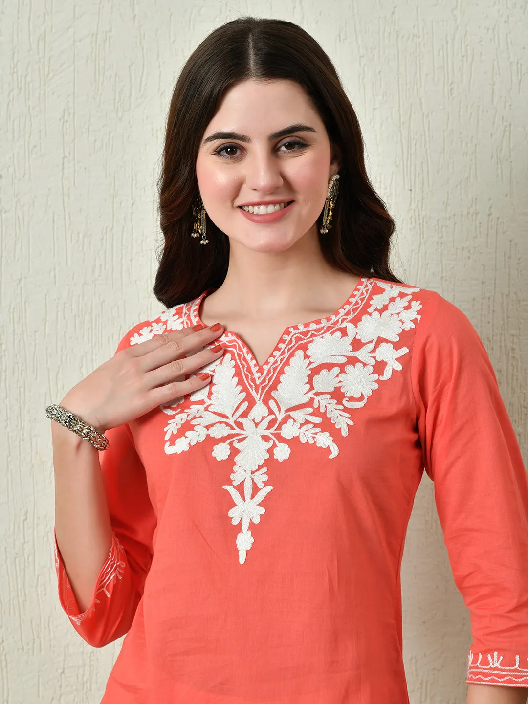 Women Stylish Peach Cotton Short Kurti With Elegant Work