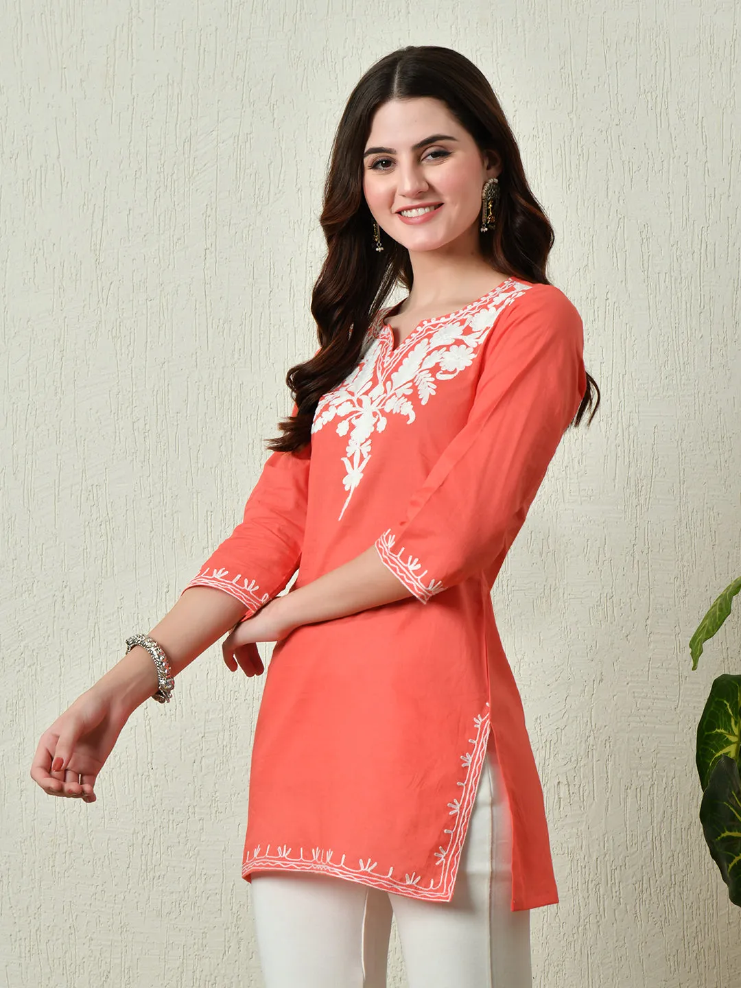 Women Stylish Peach Cotton Short Kurti With Elegant Work